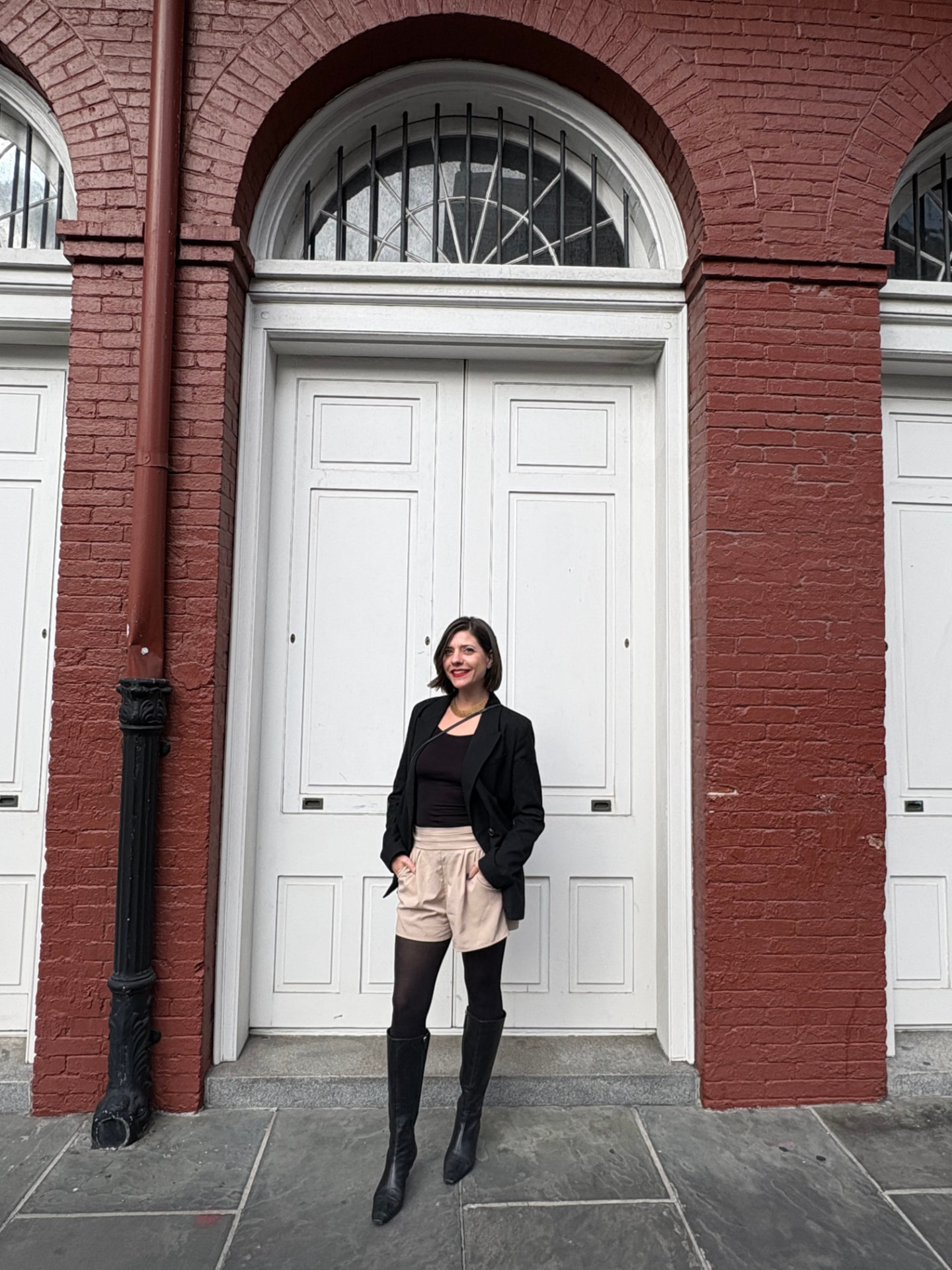 Lauren Curbelo standing in front of a white arched doorway